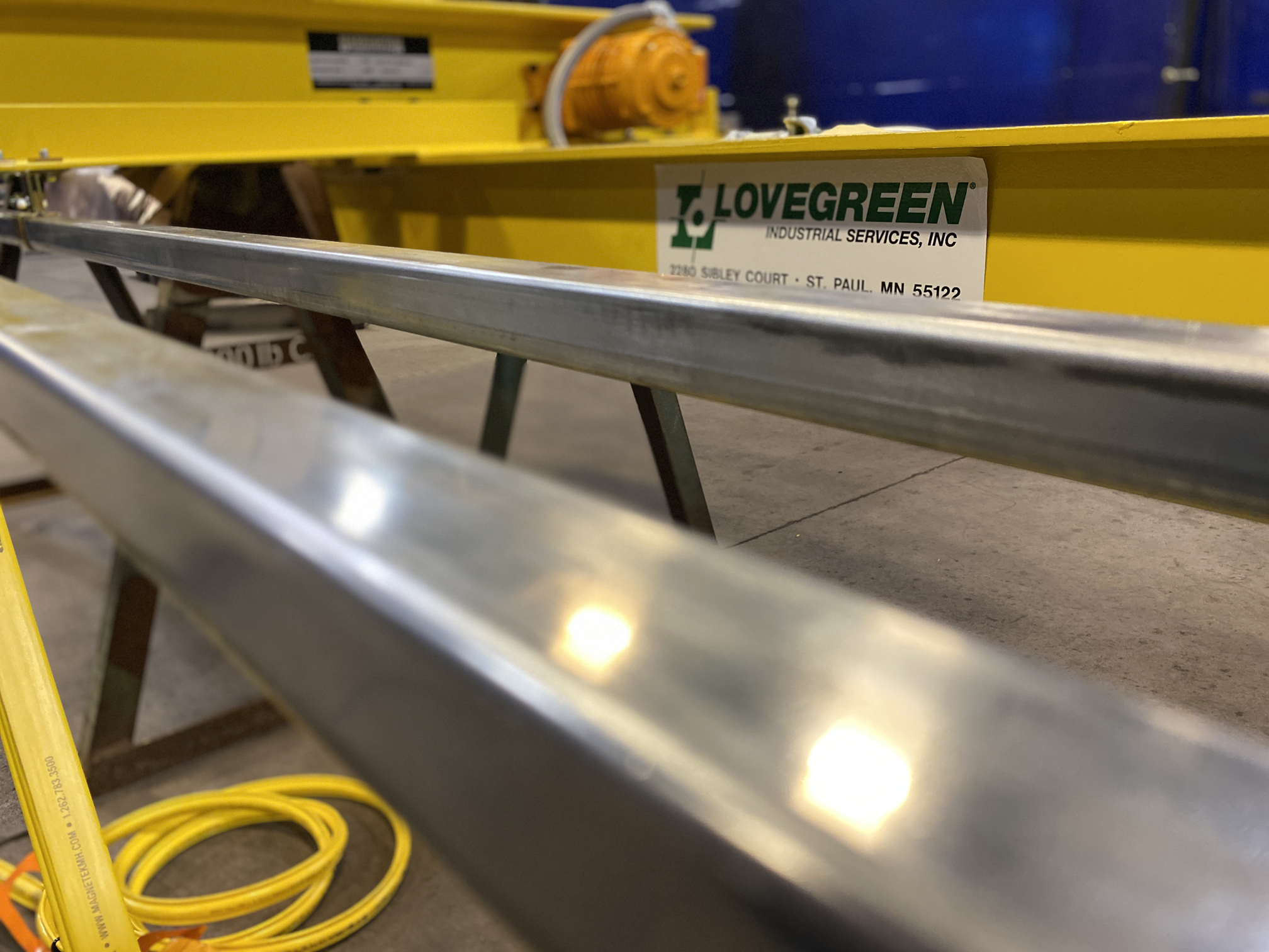 http://Close-up%20of%20custom%20metal%20rail%20fabricated%20by%20Lovegreen%20Industrial%20Services,%20with%20company%20label%20in%20focus